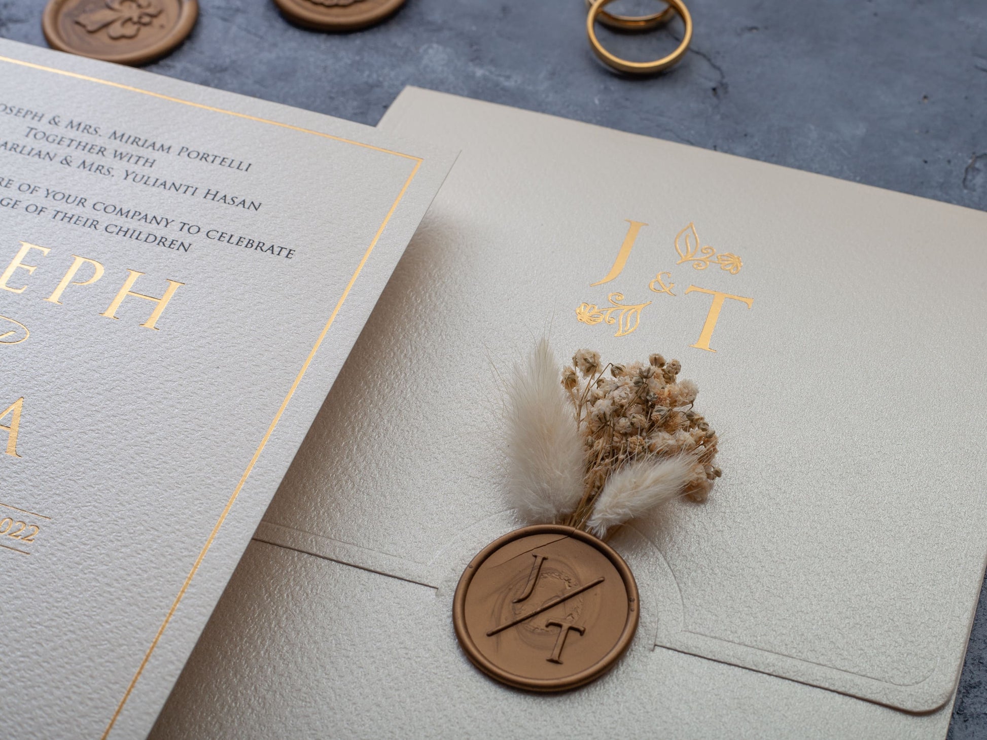 Elegant wedding invitation with wax seal and fried flowers