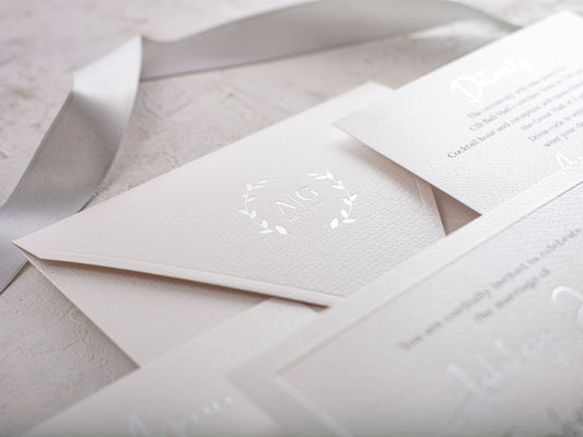 Elegant white paper wedding invitation with silver foil print