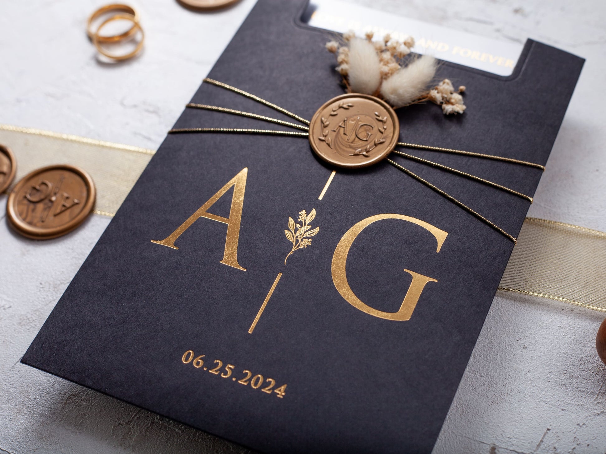 Gold foil printed acrylic invitation with black pocket type envelope, gold wax & seal and dried flowers