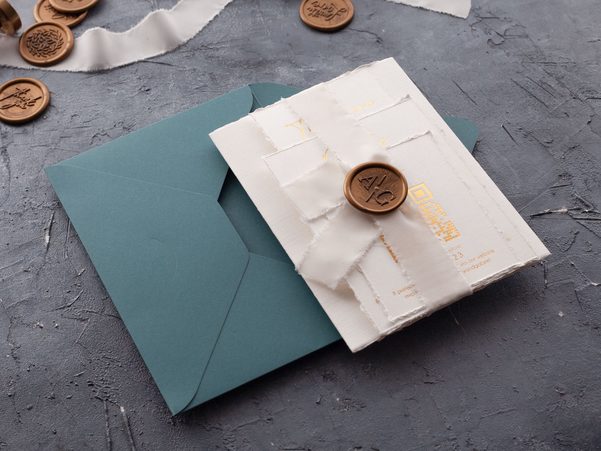 Deckled edge wedding invitation with ribbon and wax seal