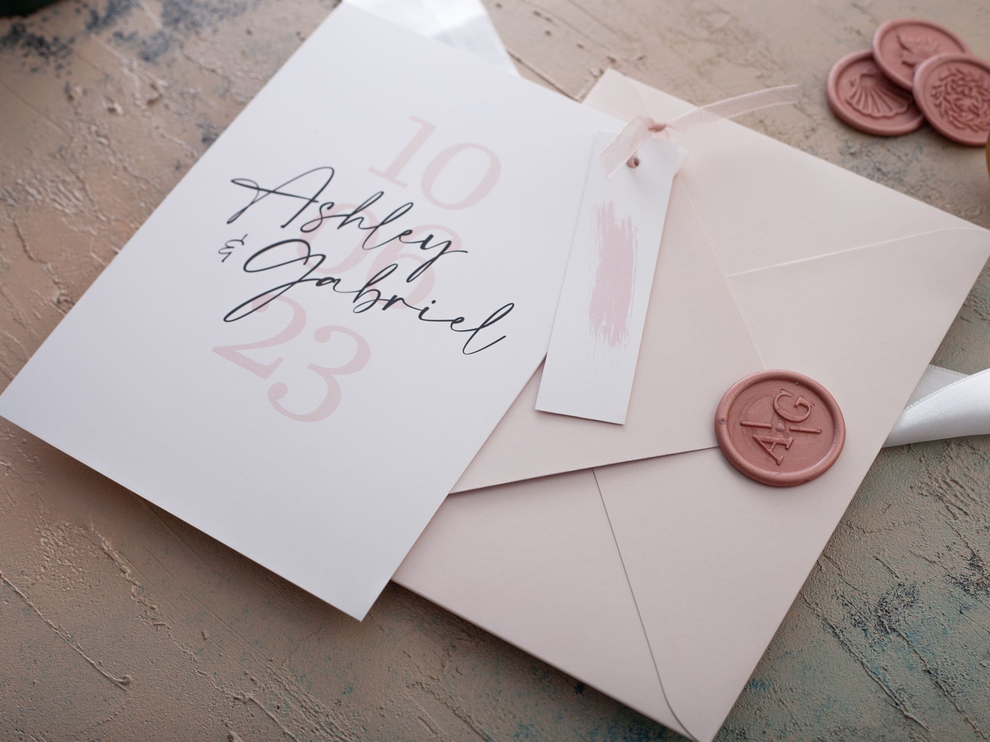 Modern wedding invitation with pink envelope and name tag