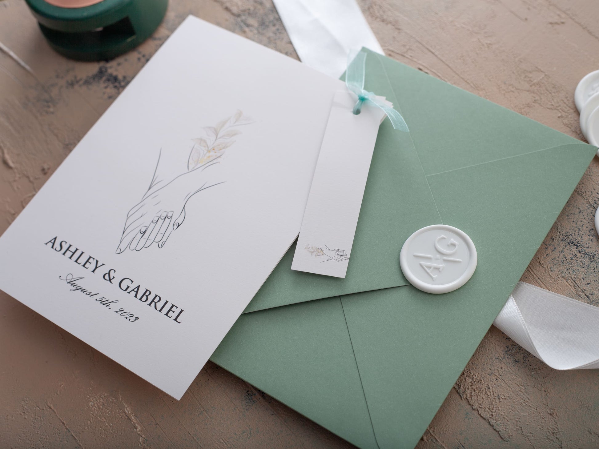 Simple and modern wedding invitation with sage green envelope and white wax seal