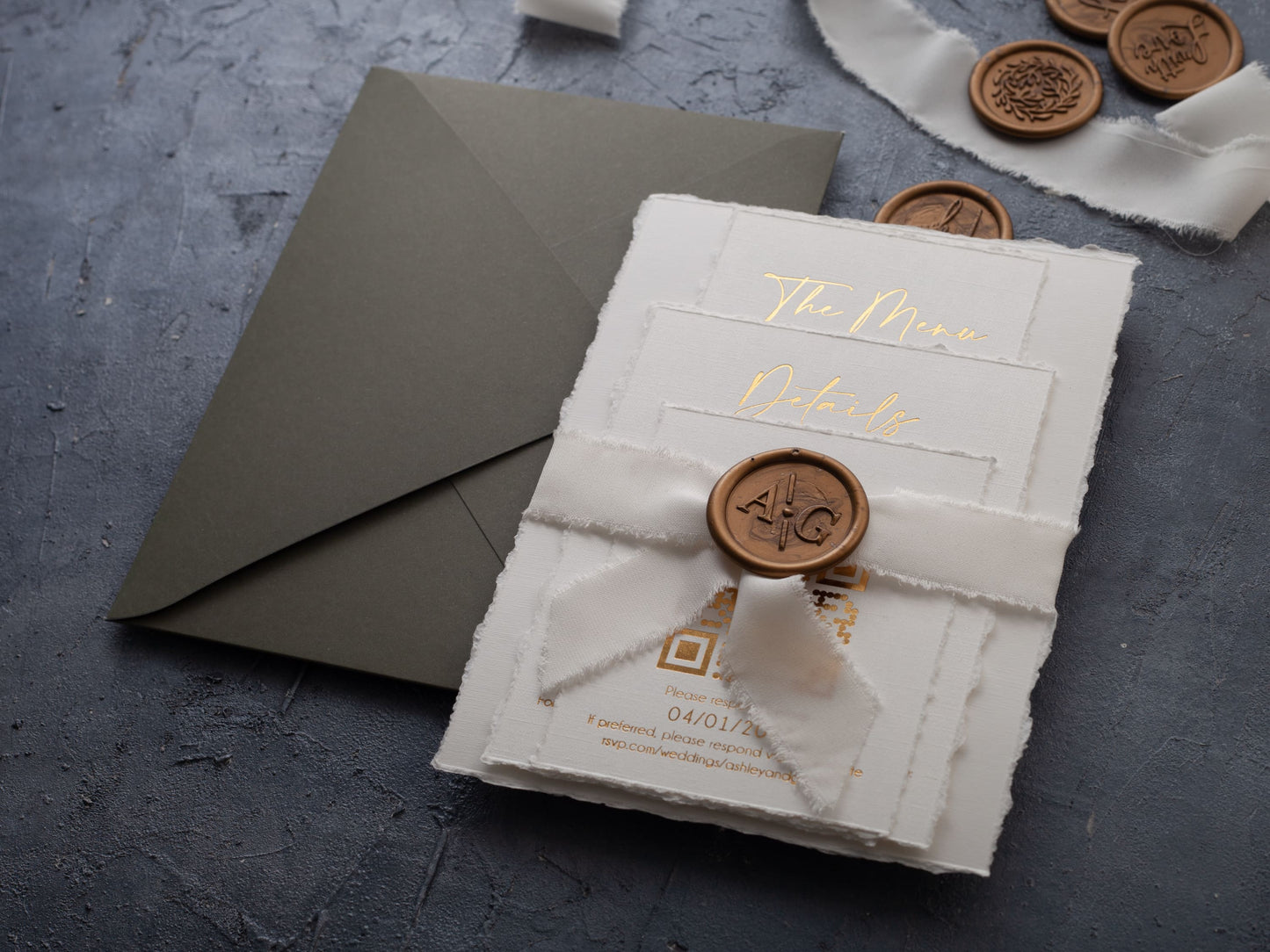Deckled edge wedding invitation set assembled with ribbon and wax seal